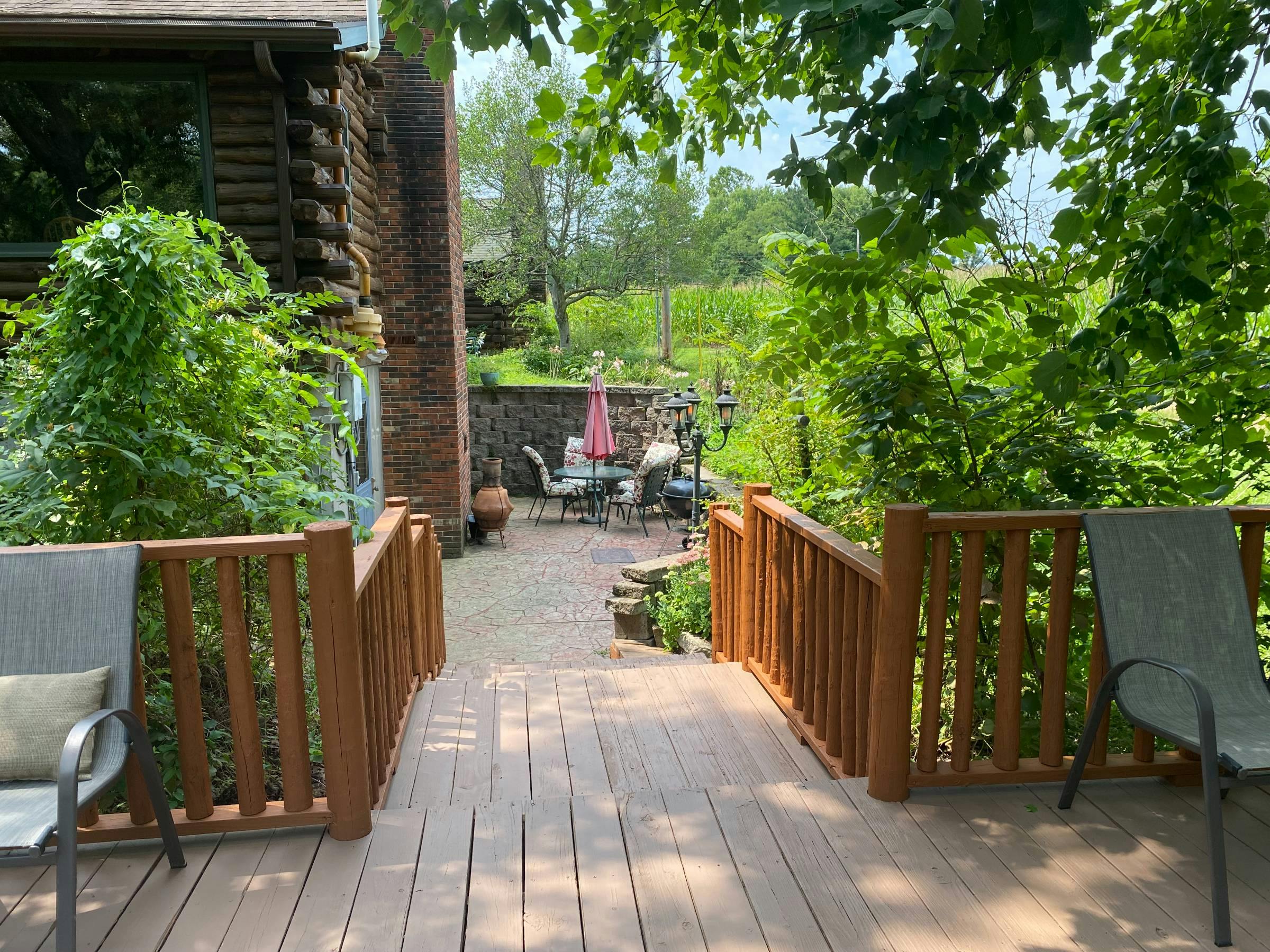 The custom wood deck with seating was recently painted and refreshed - these wide steps lead down to the Kitchen Flat patio and entrance. The wood deck and seating is available to all of our guests.